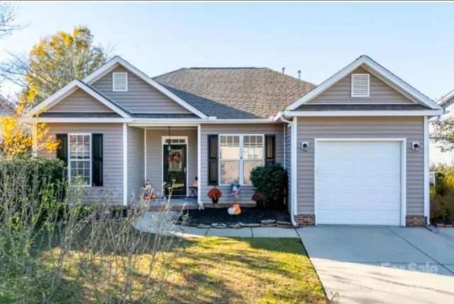 a view of a house with swimming pool and furniture