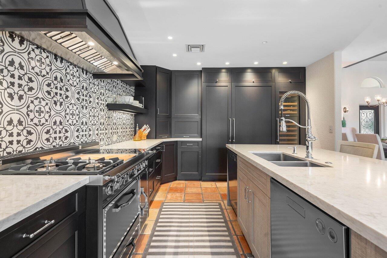 601 Phillips Drive Boca Raton, FL 33432 - Photo 15 of 56 a kitchen with stainless steel appliances granite countertop a sink stove and cabinets