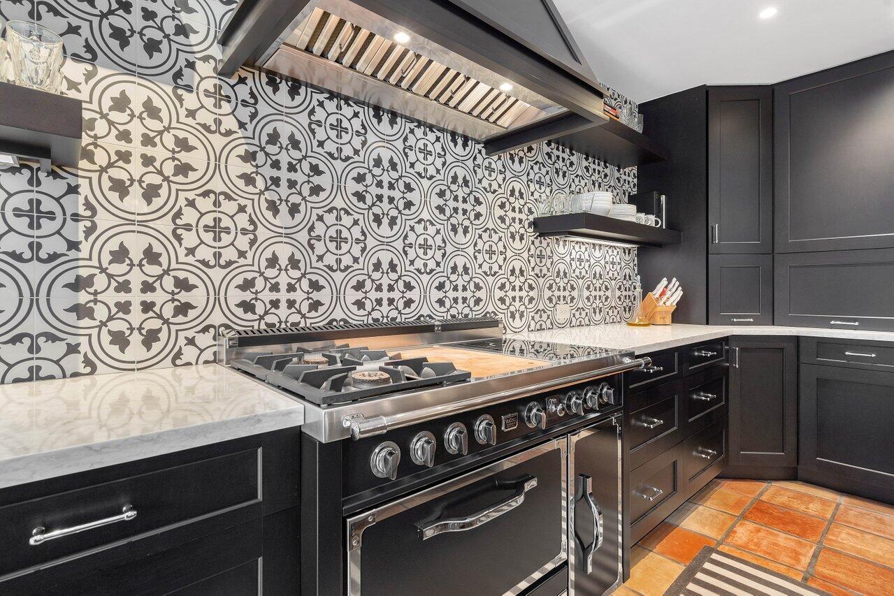 601 Phillips Drive Boca Raton, FL 33432 - Photo 16 of 56 a kitchen with a stove and a sink