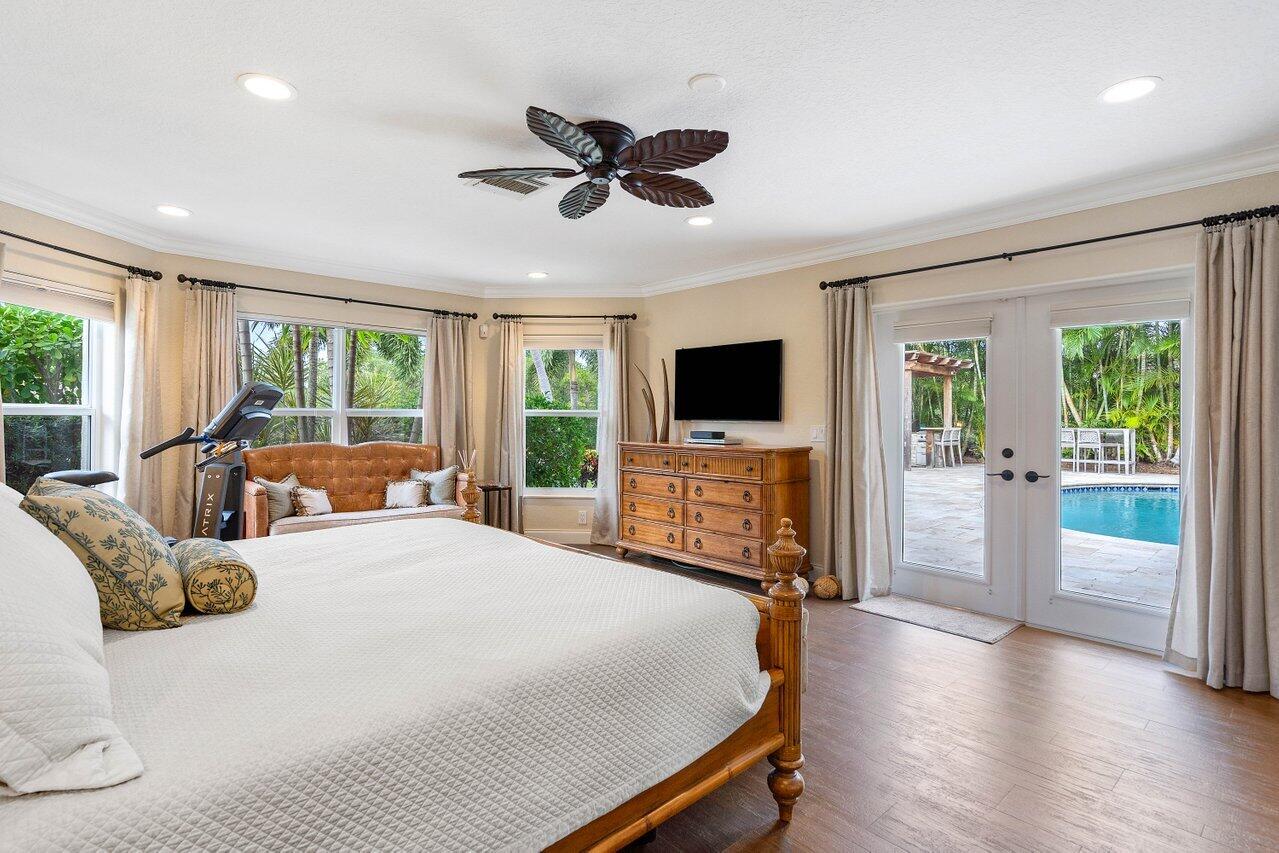 601 Phillips Drive Boca Raton, FL 33432 - Photo 18 of 56 a bedroom with a bed and a flat screen tv