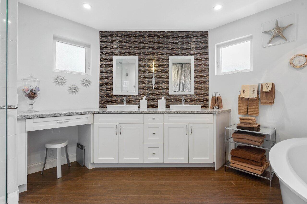 601 Phillips Drive Boca Raton, FL 33432 - Photo 21 of 56 a bathroom with a sink double vanity and a mirror
