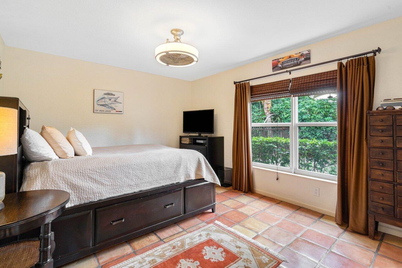 601 Phillips Drive Boca Raton, FL 33432 - Photo 26 of 56 a bedroom with a bed and glass window