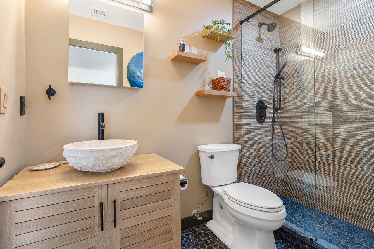 601 Phillips Drive Boca Raton, FL 33432 - Photo 27 of 56 a bathroom with a toilet a sink and shower