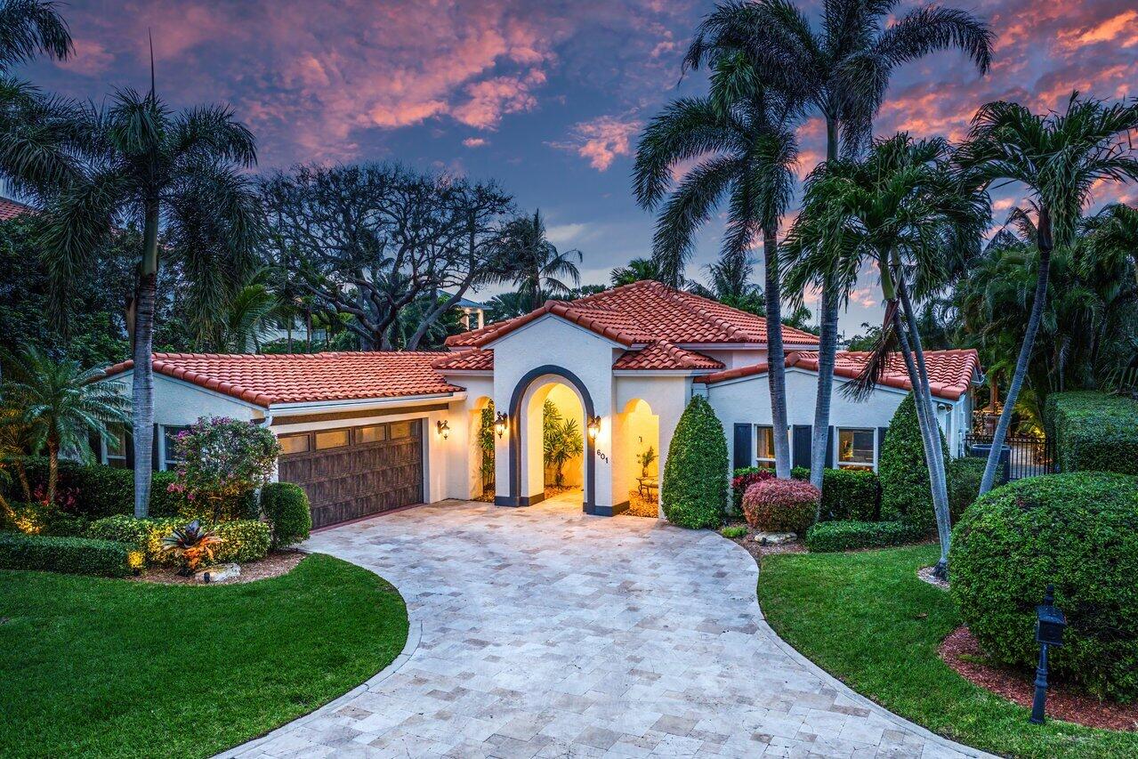 601 Phillips Drive Boca Raton, FL 33432 - Photo 3 of 56 a front view of a house with a garden and trees