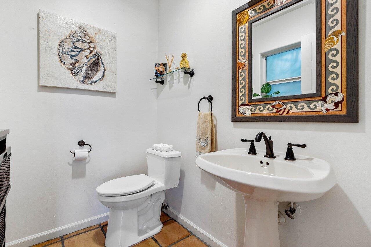 601 Phillips Drive Boca Raton, FL 33432 - Photo 31 of 56 a bathroom with a toilet sink and mirror