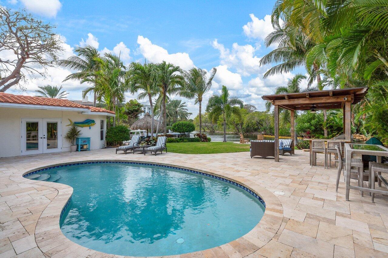 601 Phillips Drive Boca Raton, FL 33432 - Photo 35 of 56 a view of a swimming pool with a sitting space