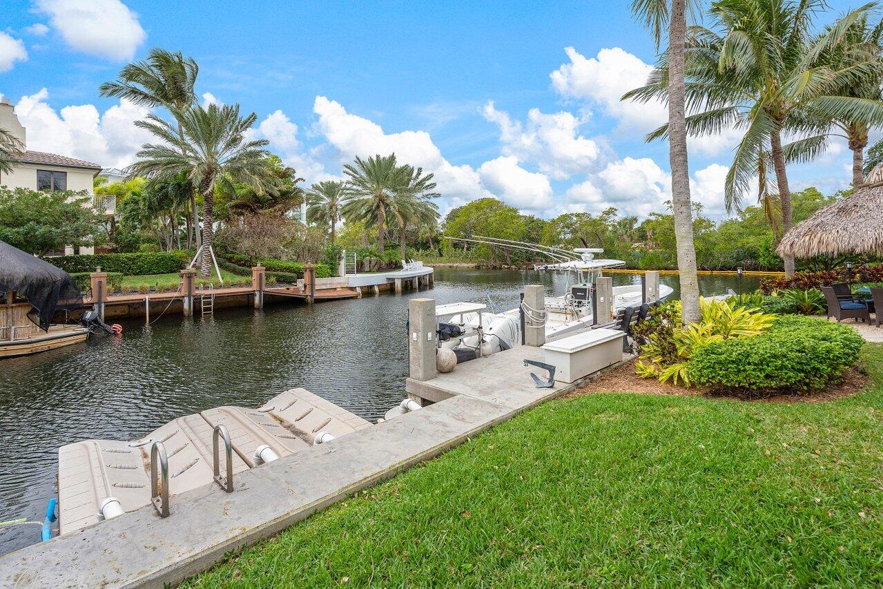 601 Phillips Drive Boca Raton, FL 33432 - Photo 43 of 56 a view of a lake with a garden and swimming pool