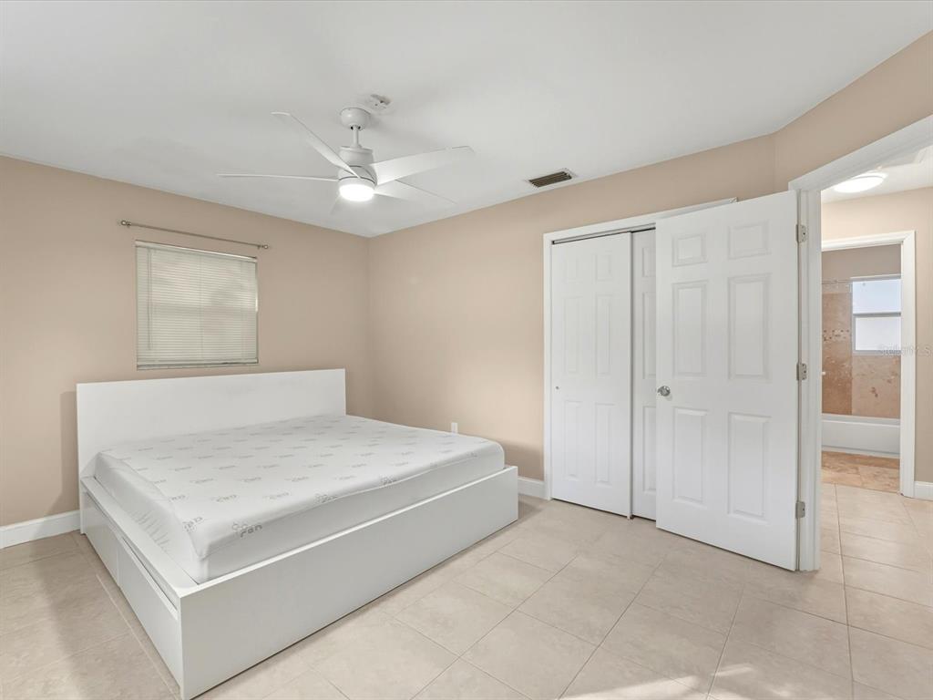 1017 Rosedale Road Venice, FL 34293 - Photo 14 of 30 a bedroom with a bed and a ceiling fan