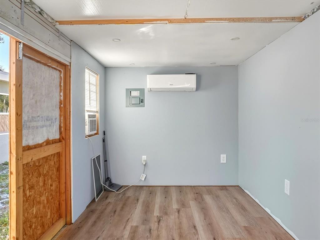 1017 Rosedale Road Venice, FL 34293 - Photo 22 of 30 a view of a room with wooden floor and a window