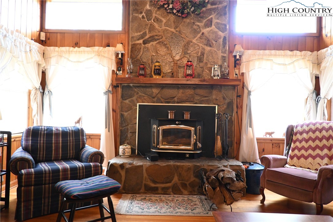 280 Smoky Hollow Road Laurel Springs, NC 28644 - Photo 10 of 42 a living room with furniture a flat screen tv and a fireplace