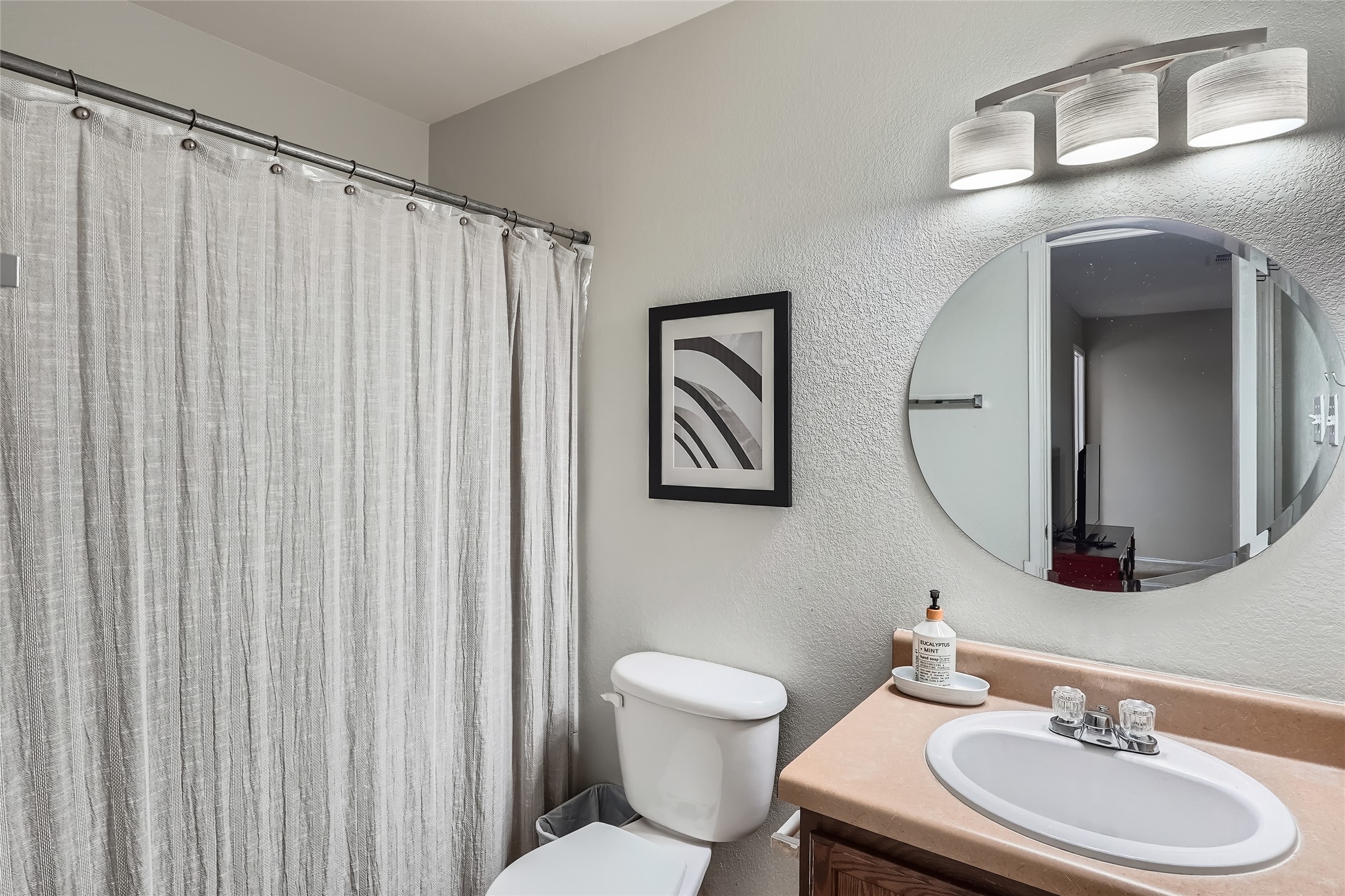 18021 Prairie Verbena Lane Elgin, TX 78621 - Photo 13 of 33 A well-lit primary bathroom featuring a spacious shower and a vanity with an oval mirror.