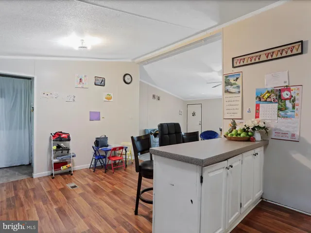 a view of a kitchen with a dining table chairs and wooden floor