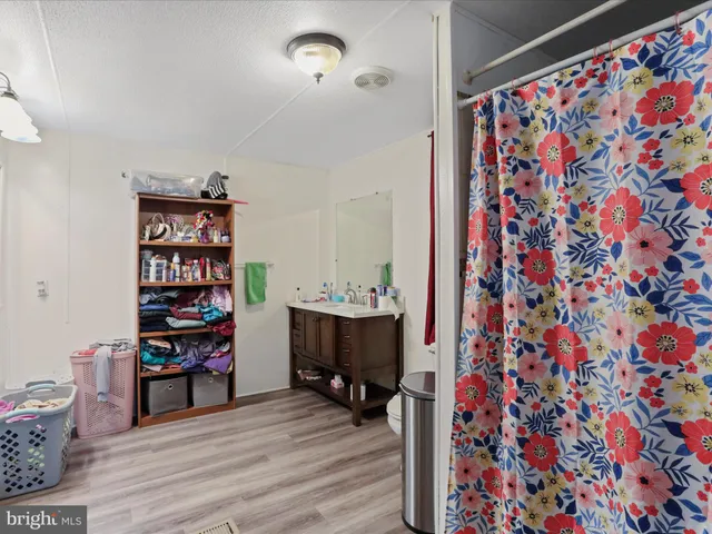 a view of a workspace with furniture and wooden floor