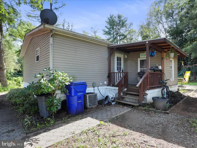 a view of a chairs and table in the backyard