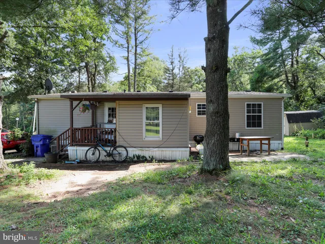 a view of a chair and table in backyard of the house