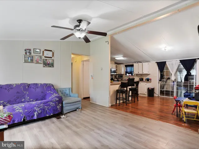 a living room with furniture and kitchen view
