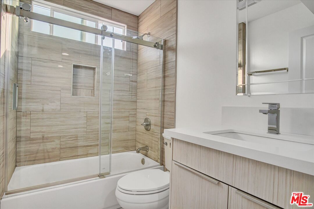 2419 South Cochran Avenue Los Angeles, CA 90016 - Photo 19 of 74 a bathroom with a sink a toilet and shower