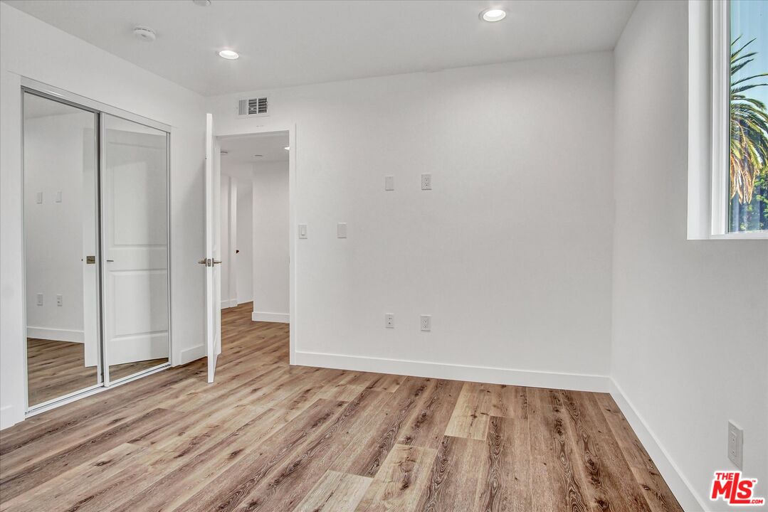2419 South Cochran Avenue Los Angeles, CA 90016 - Photo 21 of 74 wooden floor in an empty room with a window