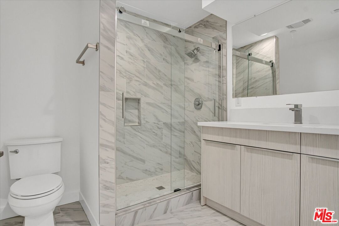 2419 South Cochran Avenue Los Angeles, CA 90016 - Photo 24 of 74 a bathroom with a shower and a toilet