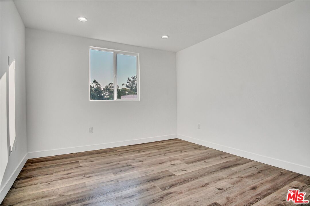 2419 South Cochran Avenue Los Angeles, CA 90016 - Photo 25 of 74 a view of an empty room with wooden floor and a window