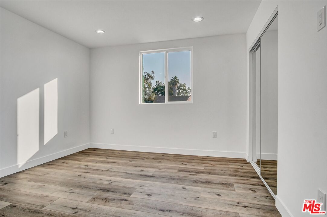2419 South Cochran Avenue Los Angeles, CA 90016 - Photo 27 of 74 a view of an empty room with wooden floor and window