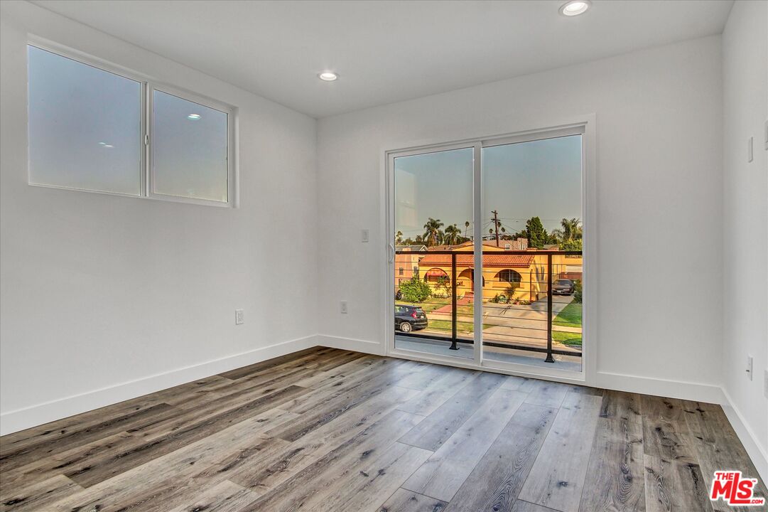 2419 South Cochran Avenue Los Angeles, CA 90016 - Photo 29 of 74 a view of an empty room with wooden floor and a window