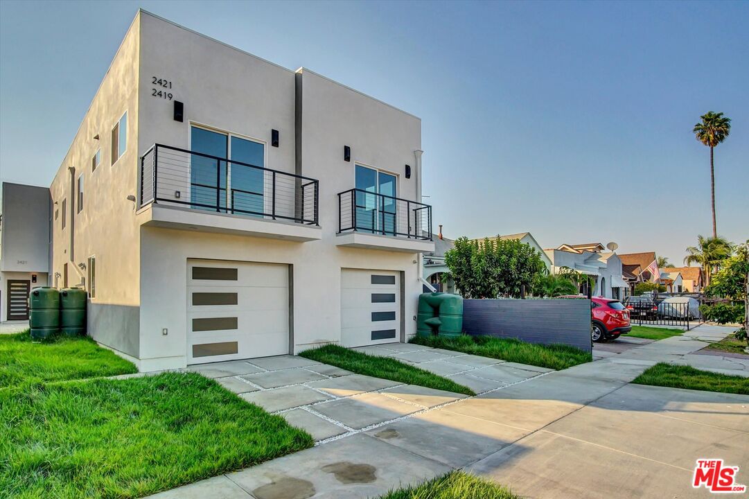 2419 South Cochran Avenue Los Angeles, CA 90016 - Photo 4 of 74 a front view of a house with a garden and plants