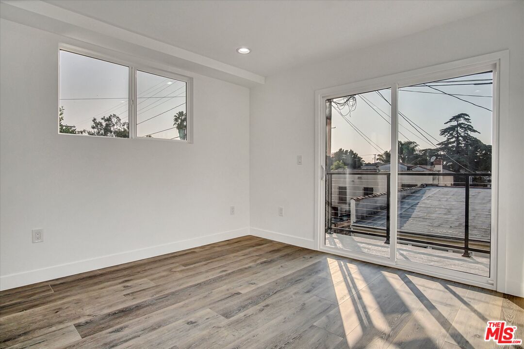 2419 South Cochran Avenue Los Angeles, CA 90016 - Photo 53 of 74 a view of empty room with wooden floor and fan