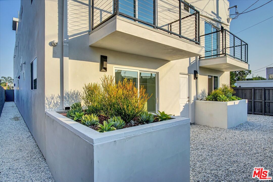 2419 South Cochran Avenue Los Angeles, CA 90016 - Photo 73 of 74 a view of a house with potted plants
