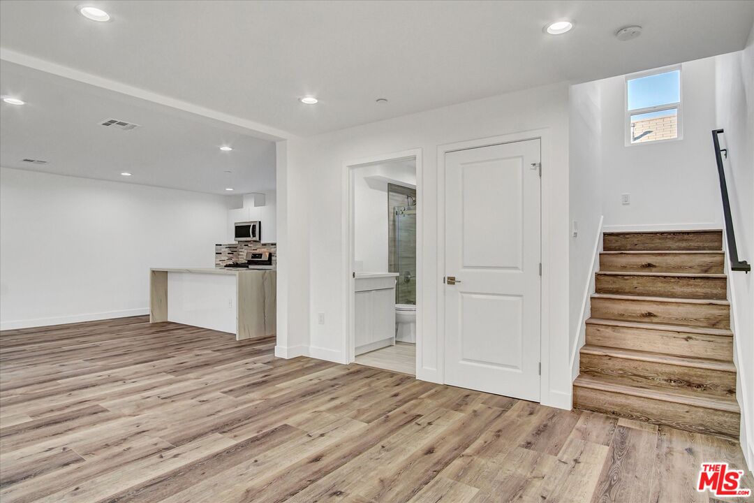 2419 South Cochran Avenue Los Angeles, CA 90016 - Photo 8 of 74 a view of a kitchen with wooden floor and a sink