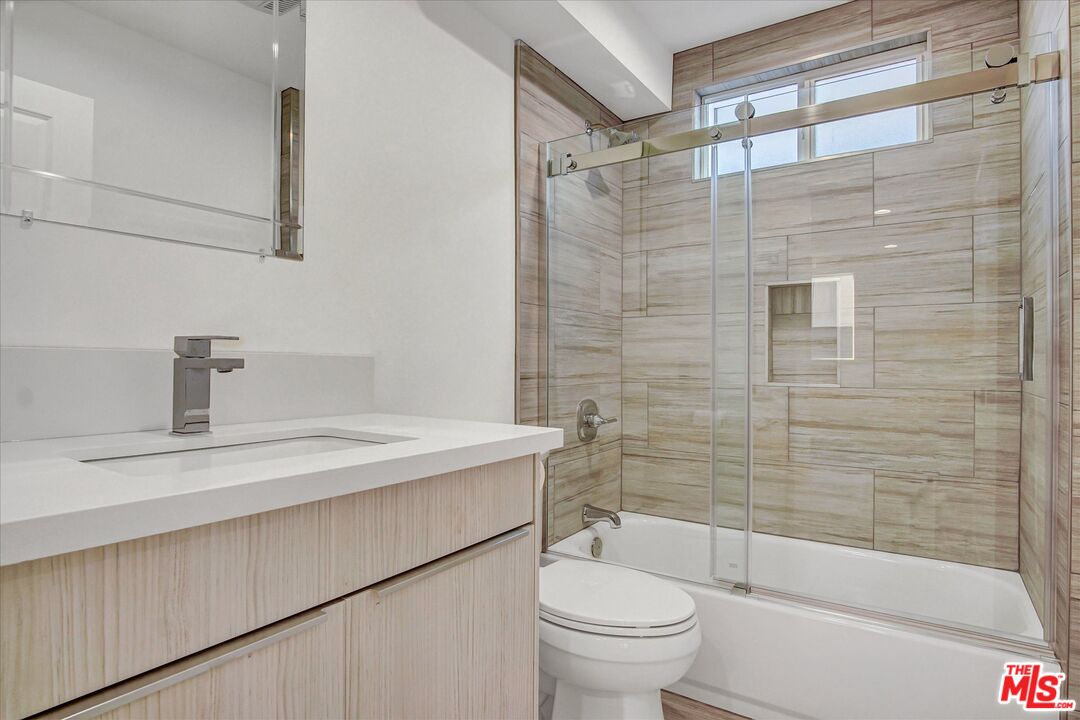 2419 South Cochran Avenue Los Angeles, CA 90016 - Photo 9 of 74 a bathroom with a sink a toilet and shower