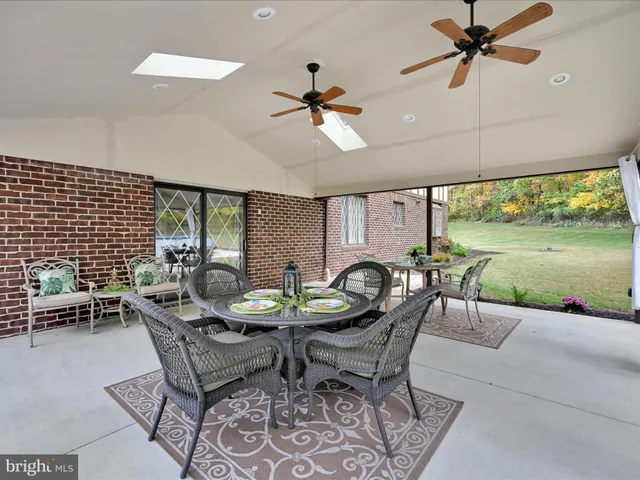 a backyard of a house with table and chairs