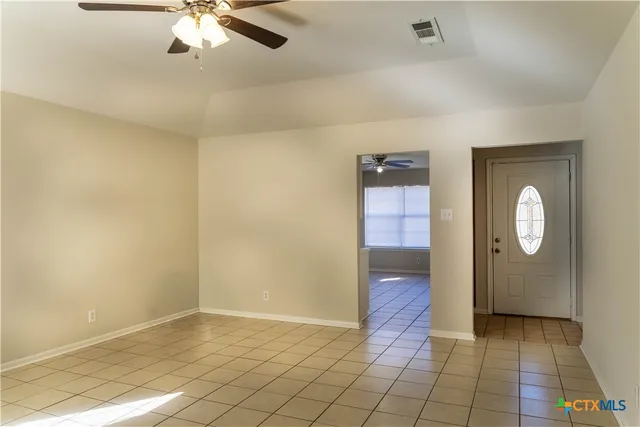 a kitchen with a sink a refrigerator and cabinets