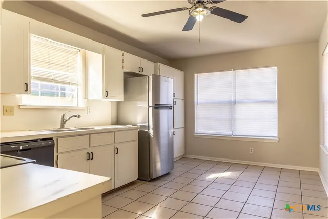 a kitchen with a sink appliances and cabinets