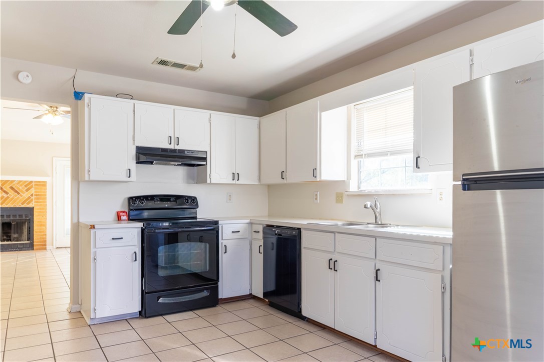 2402 Lazy Ridge Drive Killeen, TX 76543 - Photo 7 of 16 a kitchen with a sink appliances and cabinets