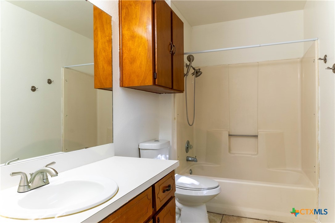 2402 Lazy Ridge Drive Killeen, TX 76543 - Photo 9 of 16 a bathroom with a granite countertop sink toilet and shower