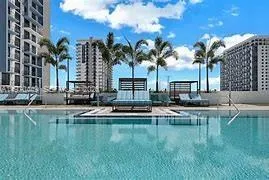 a swimming pool with outdoor seating and yard