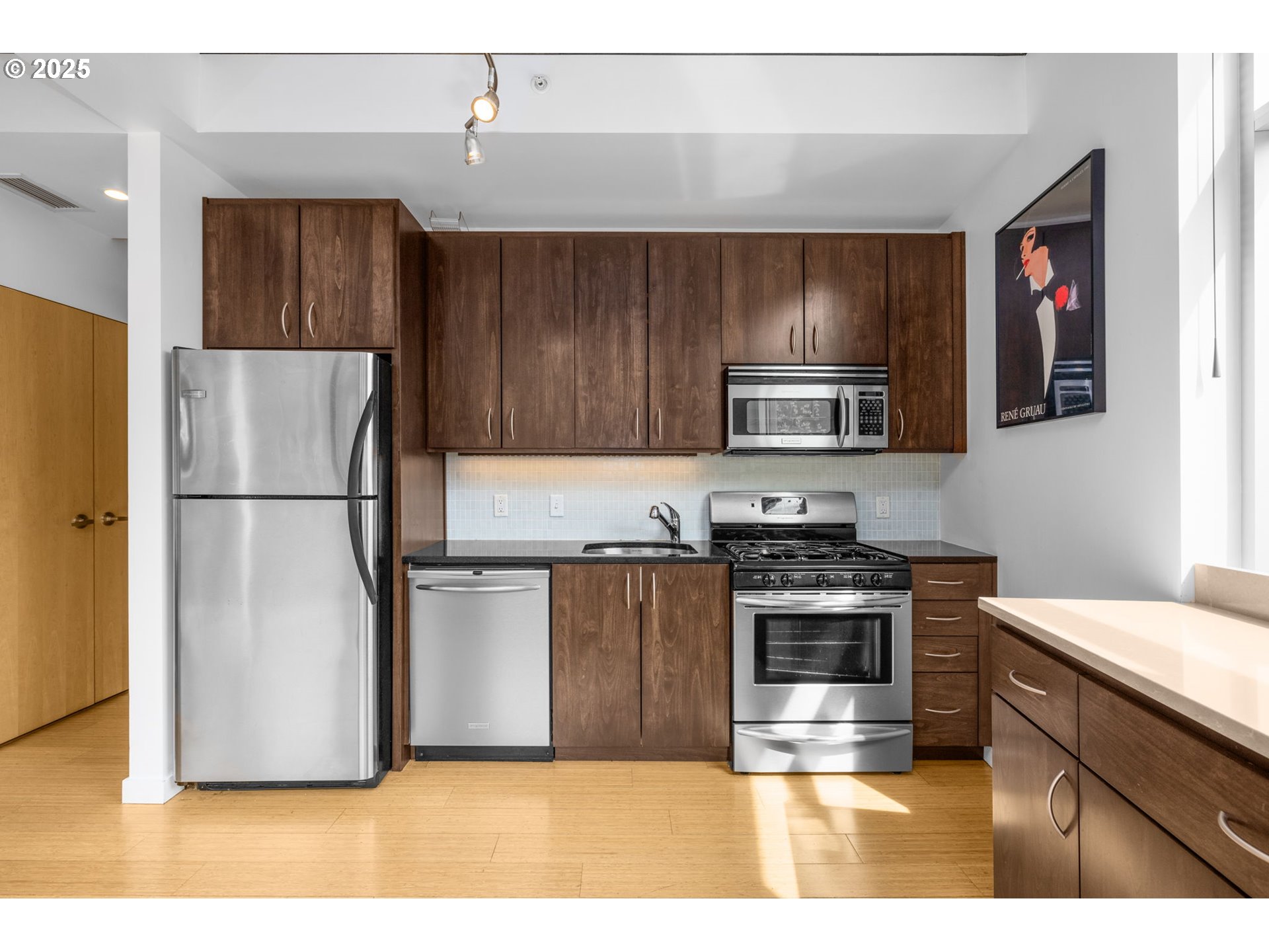 1234 Southwest 18th Avenue, Unit 305 Portland, OR 97205 - Photo 11 of 31 a kitchen with a refrigerator stove and microwave