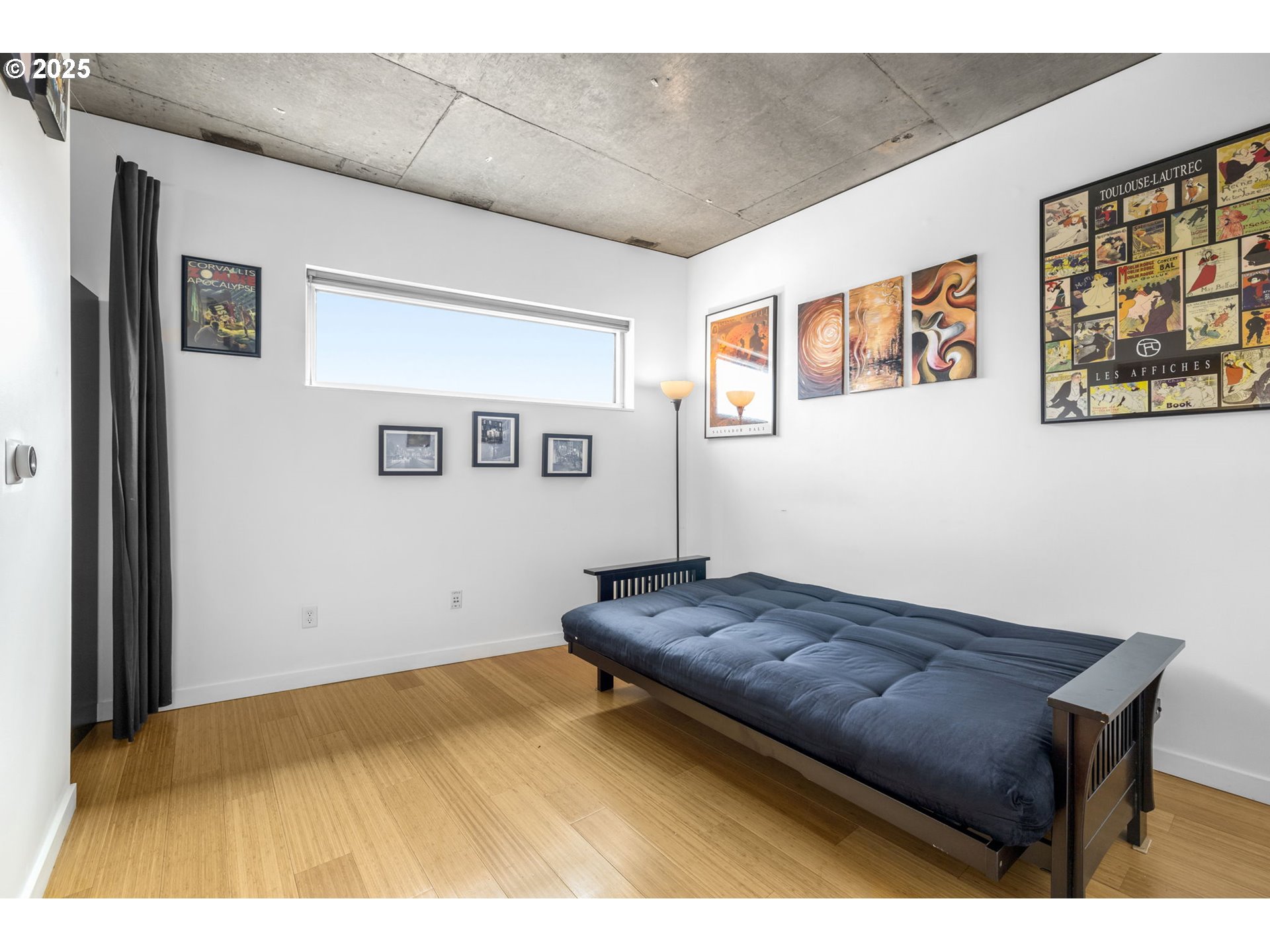1234 Southwest 18th Avenue, Unit 305 Portland, OR 97205 - Photo 16 of 31 a bedroom with a bed and wall painting