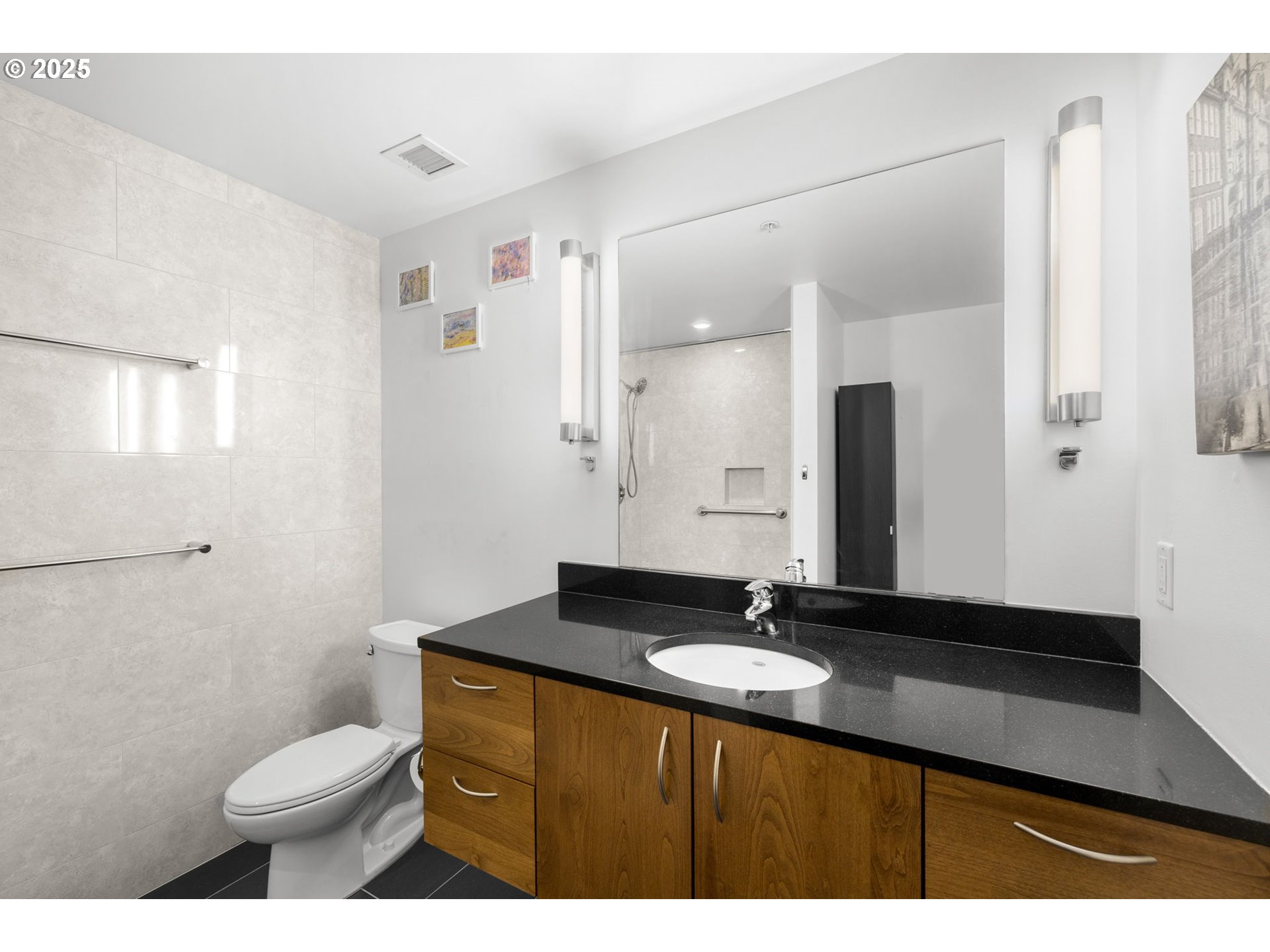 1234 Southwest 18th Avenue, Unit 305 Portland, OR 97205 - Photo 20 of 31 a bathroom with a granite countertop sink toilet and mirror