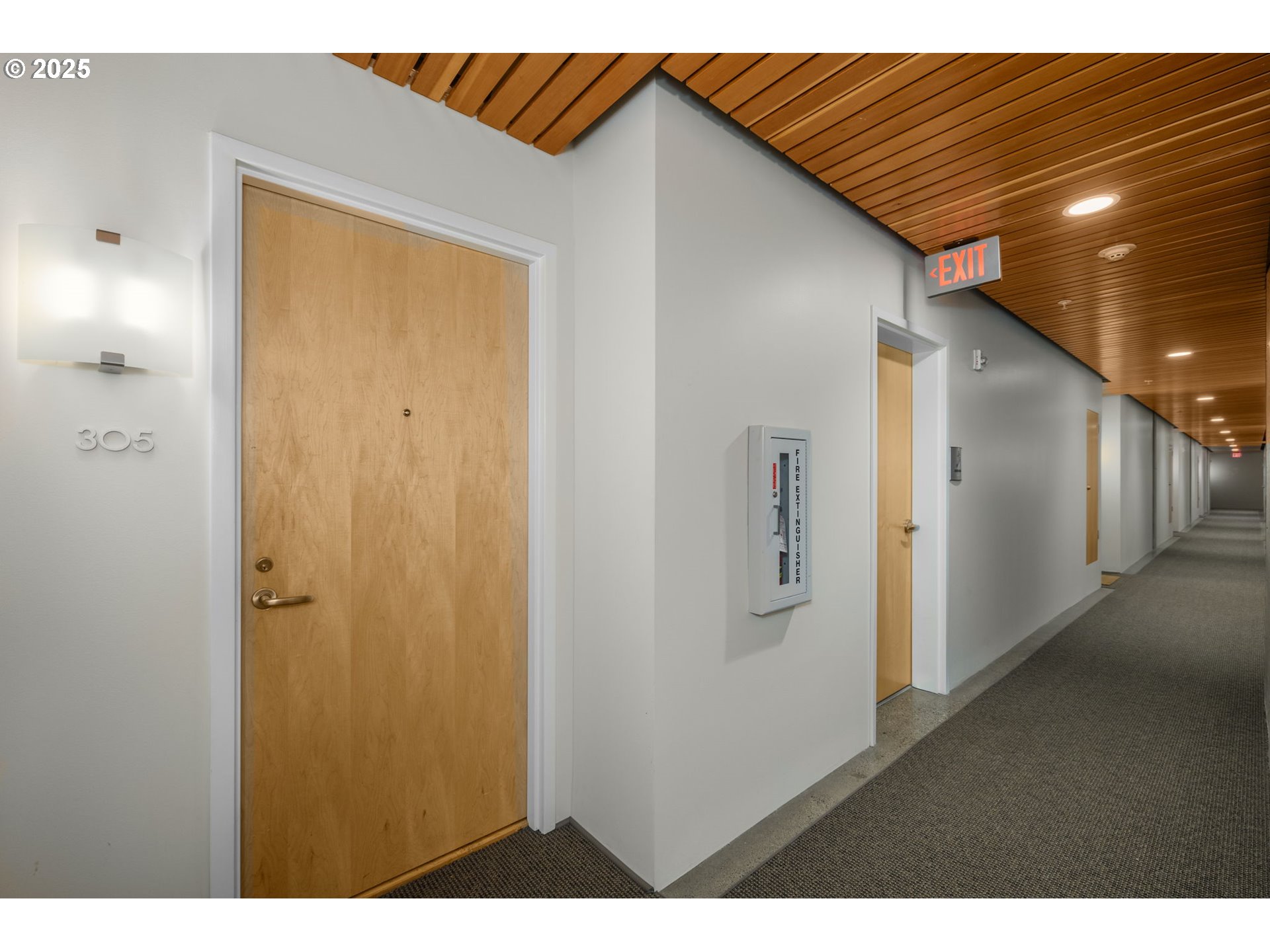 1234 Southwest 18th Avenue, Unit 305 Portland, OR 97205 - Photo 23 of 31 a view of a hallway with wooden floor and staircase