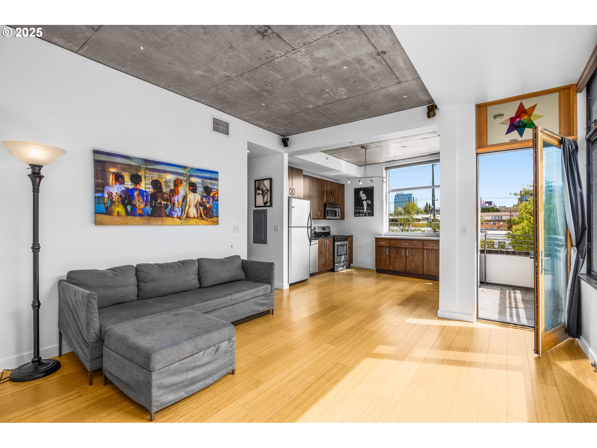 1234 Southwest 18th Avenue, Unit 305 Portland, OR 97205 - Photo 4 of 31 a living room with furniture and a view of kitchen
