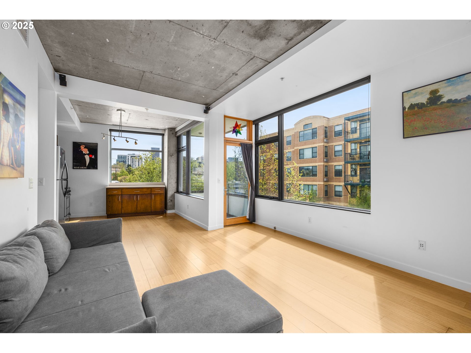 1234 Southwest 18th Avenue, Unit 305 Portland, OR 97205 - Photo 5 of 31 a living room with furniture and a large window