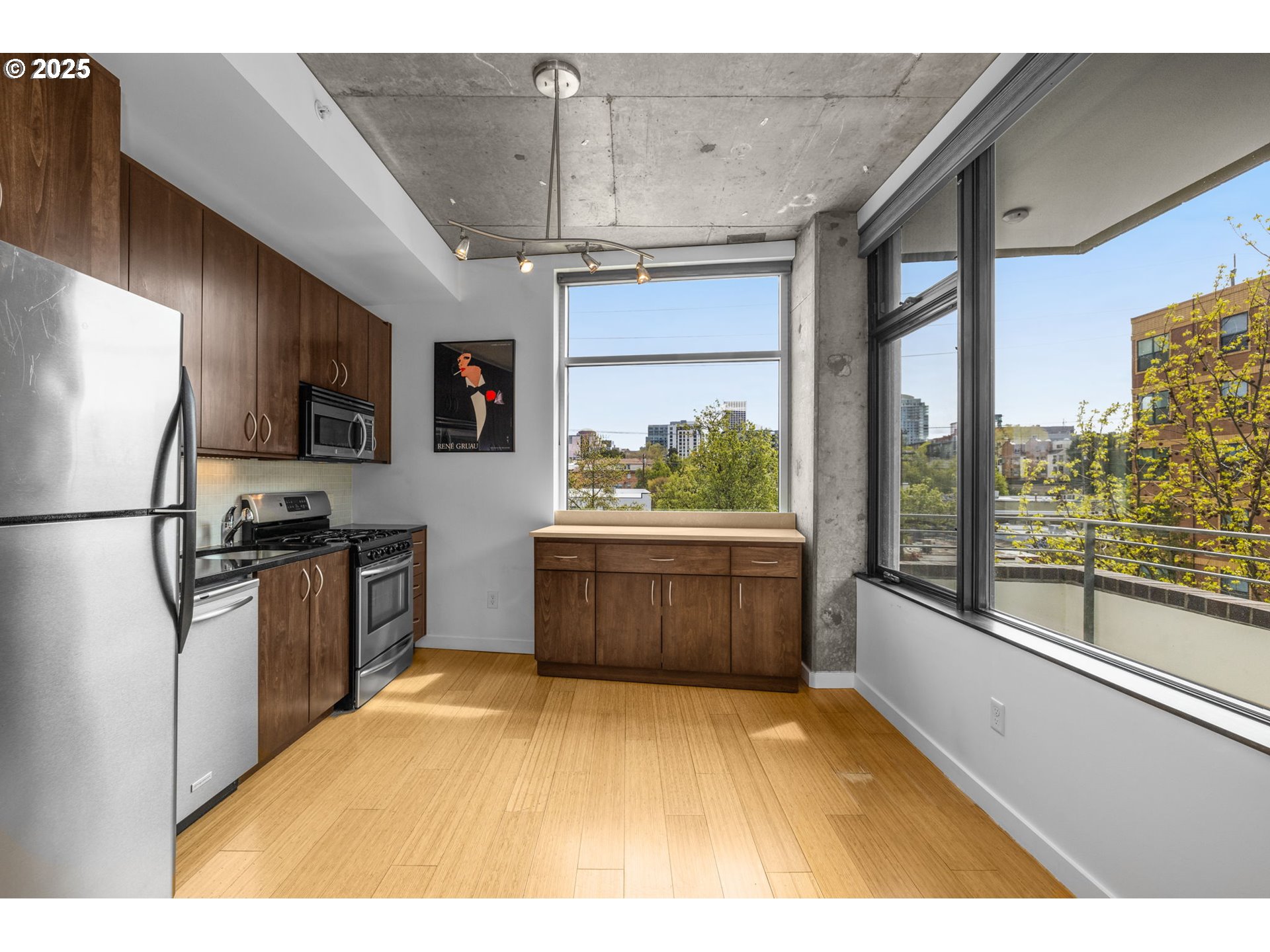 1234 Southwest 18th Avenue, Unit 305 Portland, OR 97205 - Photo 10 of 31 a kitchen with stainless steel appliances kitchen island granite countertop a refrigerator a stove top oven a sink and dishwasher