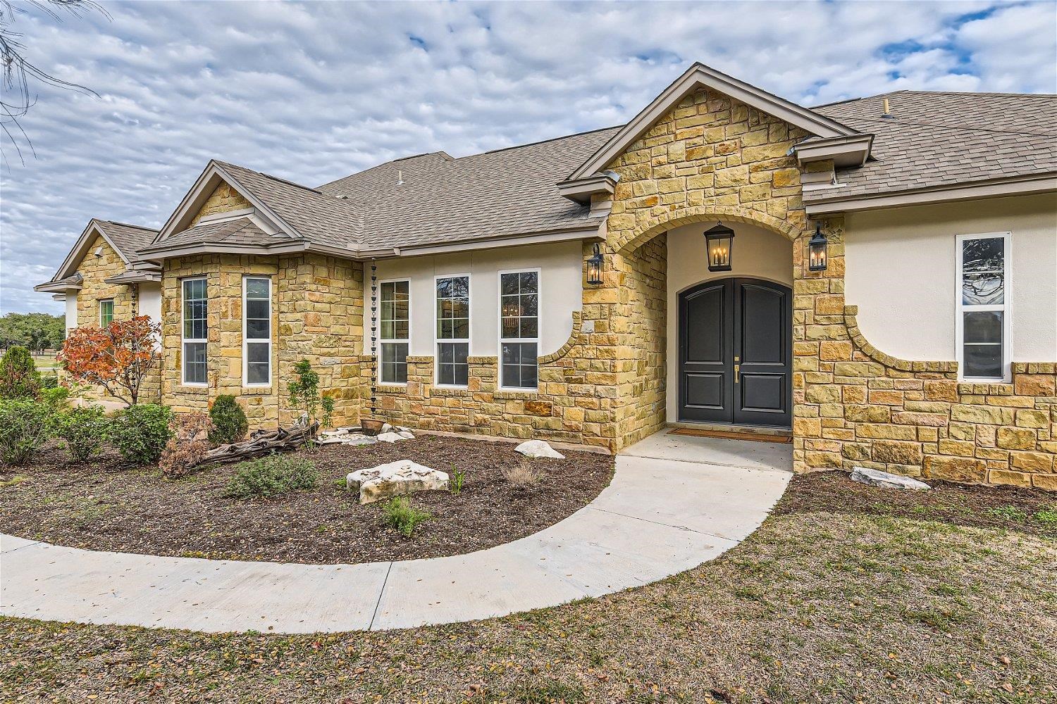 113 Vista View Trail Spicewood, TX 78669 - Photo 2 of 30 front view of a house with a yard
