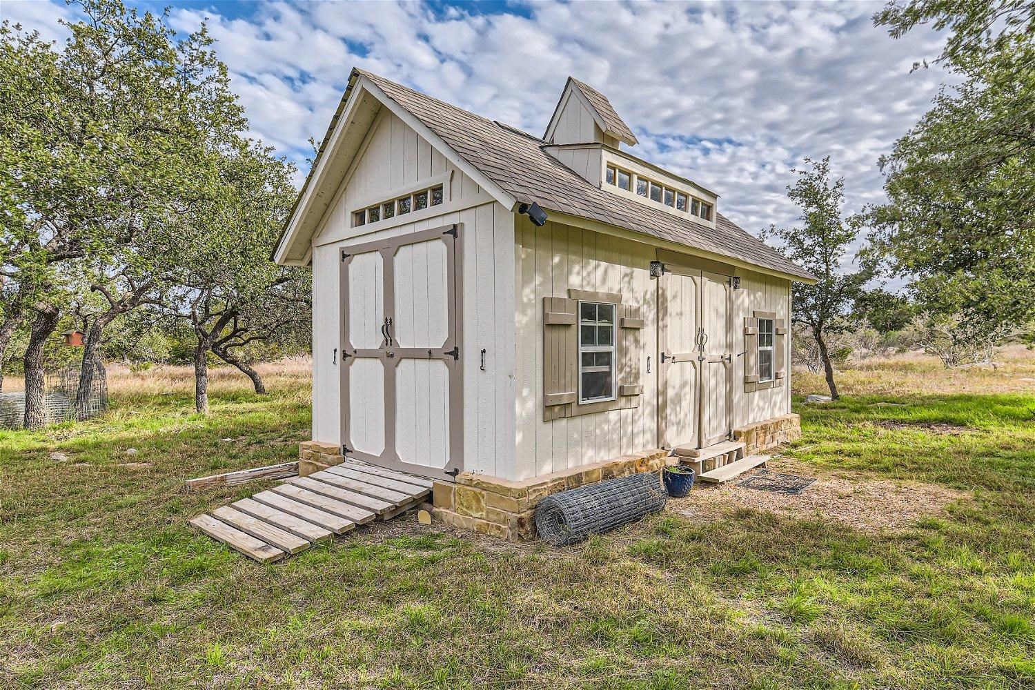 113 Vista View Trail Spicewood, TX 78669 - Photo 29 of 30 a front view of a house with garden