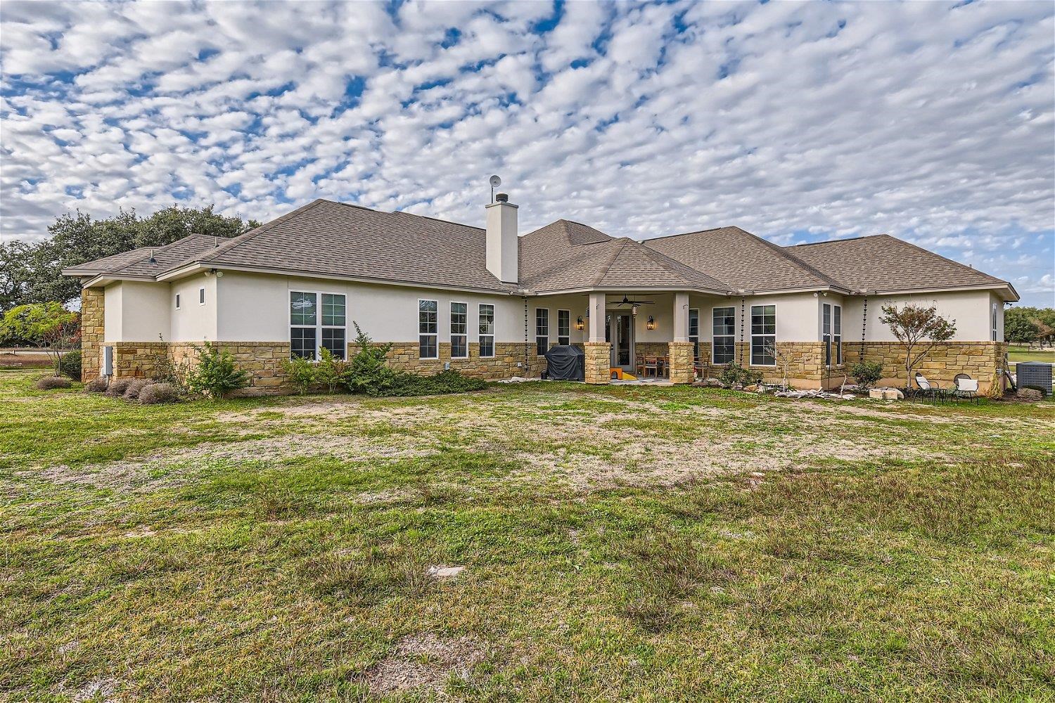 113 Vista View Trail Spicewood, TX 78669 - Photo 30 of 30 a front view of a house with a garden