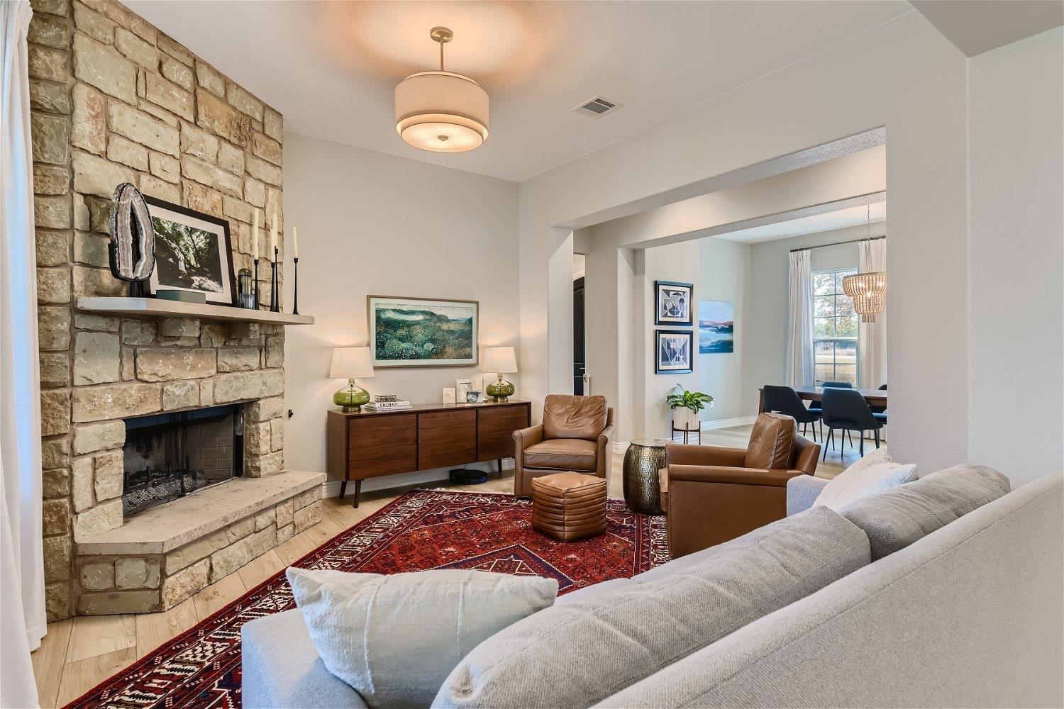 113 Vista View Trail Spicewood, TX 78669 - Photo 4 of 30 a living room with furniture a flat screen tv and a fireplace