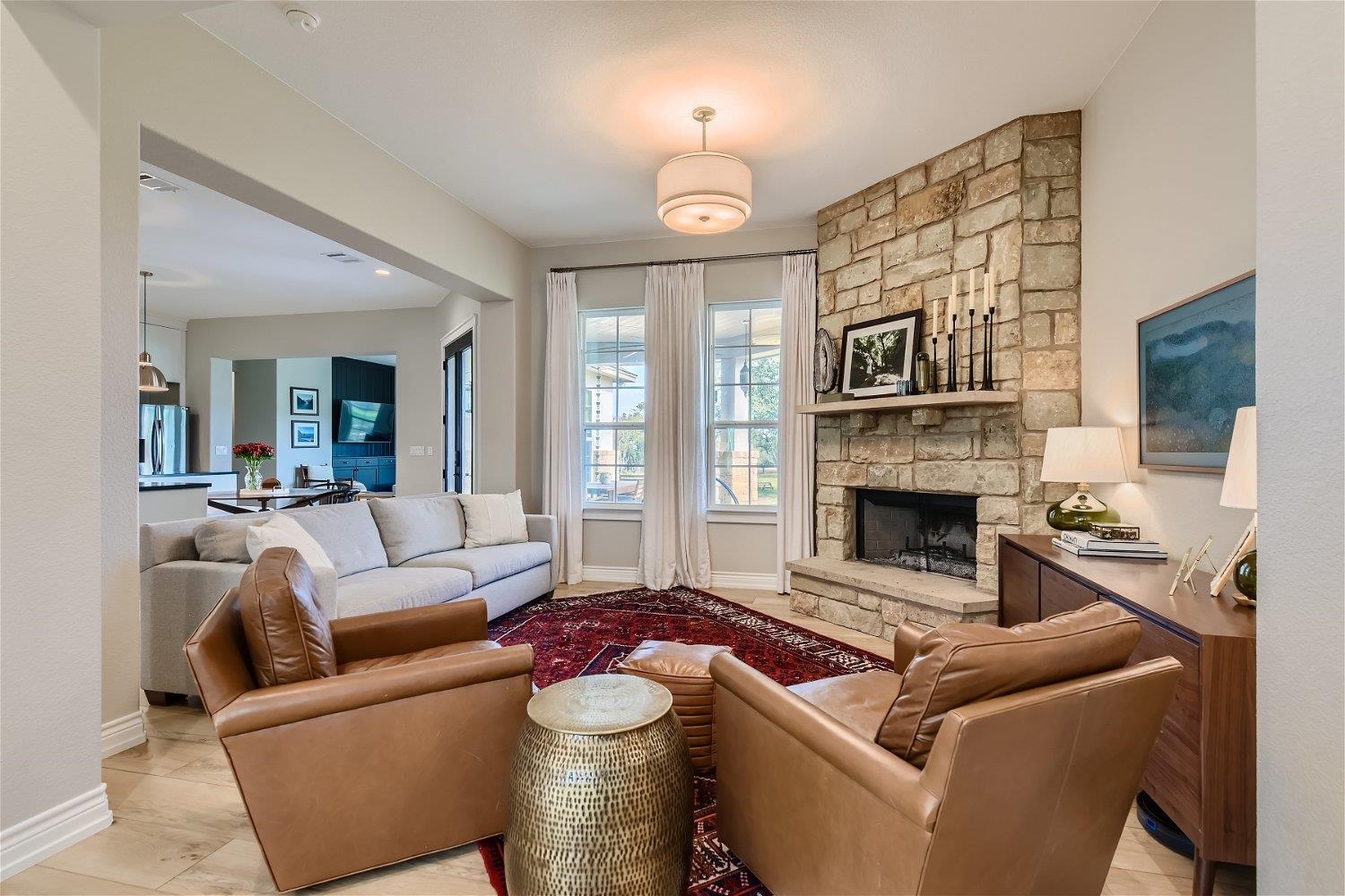 113 Vista View Trail Spicewood, TX 78669 - Photo 5 of 30 a living room with furniture a large window and a fireplace