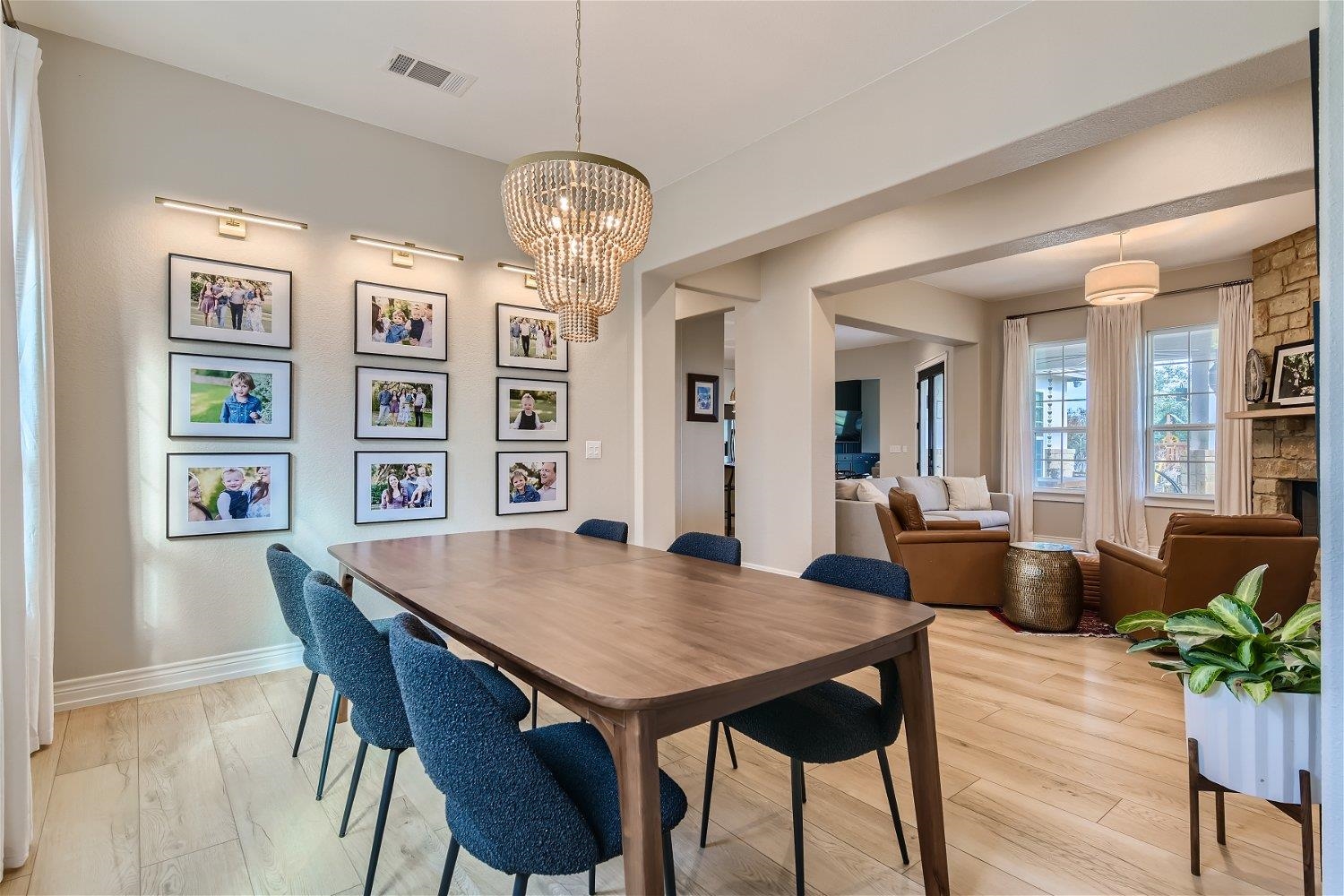 113 Vista View Trail Spicewood, TX 78669 - Photo 6 of 30 a view of a dining room with furniture wooden floor and chandelier